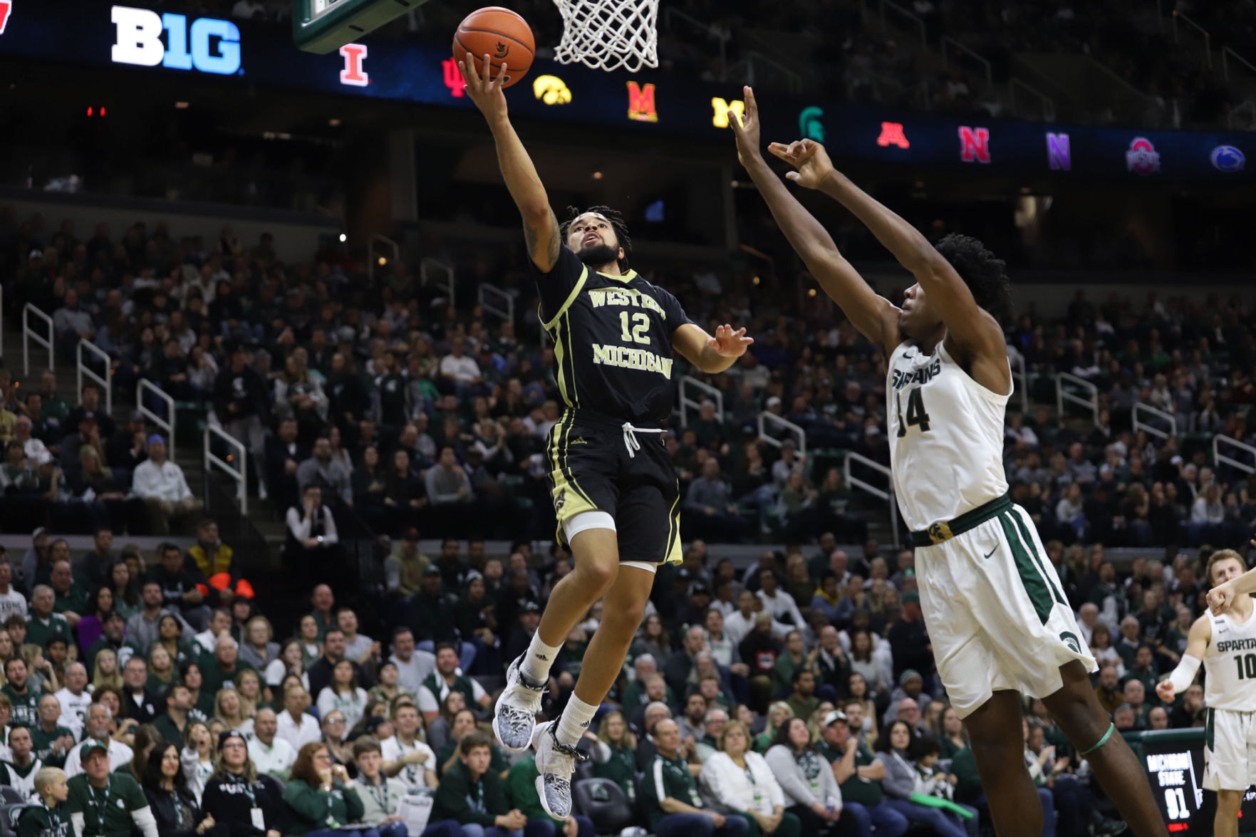 Junior guard Mike Flowers goes up for a layup over the top of Michigan State's Xavier Henry
